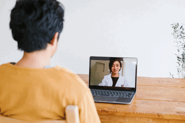 Person on video call with healthcare professional about concussion symptoms.